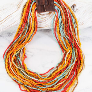 A multi strand glass bead necklace in orange, bronze and red finished with a handmade wooden clasp