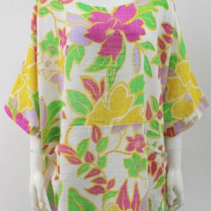 A white short sleeve top with two front pockets and a bright floral print in yellow pink and bright green