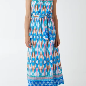 a girl against a white background wearing a diamond printed blue halter neck maxi dress