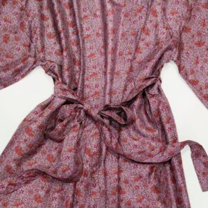 a silk kimono tied at the waist in a plum colour with a floral print