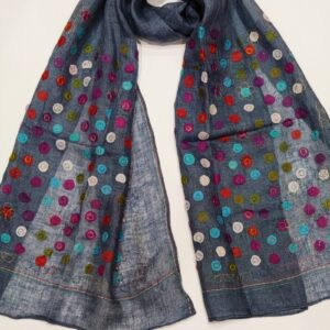 A linen woven scarf covered in multicoloured dots