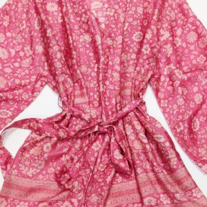 A silk kimono tied at the waist in a pink paisly print