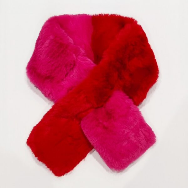 A two tone faux fur scarf in red and pink with a tuck through on a white background