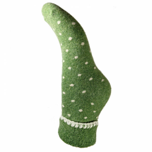 a single wool sock in green with white dots all over it, a turn down cuff finished with blanket stitch detail