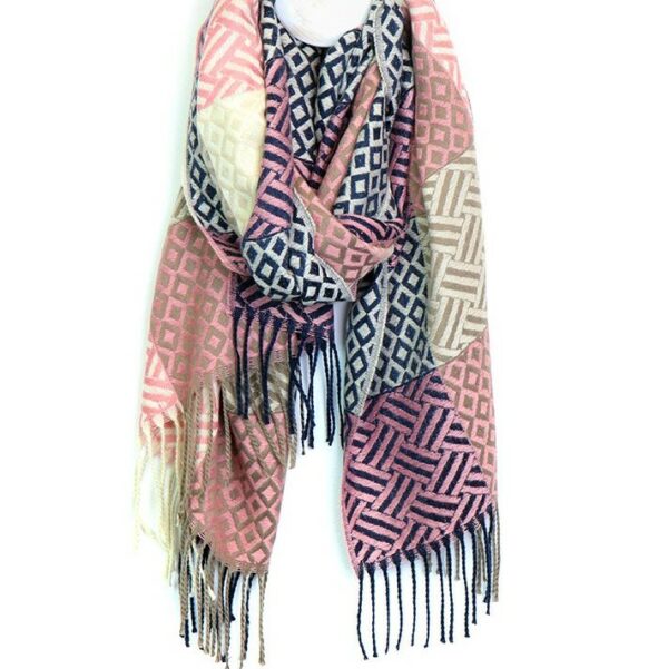 a textured woven scarf hanging on a hook in shades of navy, pink and khaki with fringe edging
