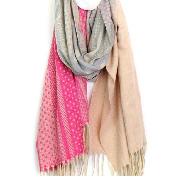 a fringed hem scarf hanging on a hook in shades of peach, grey and hot pink