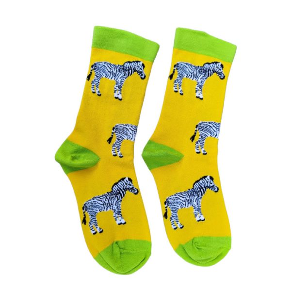 a pair of yellow socks with a design of black and white striped zebras all over and lime green toe and heel, on a white background
