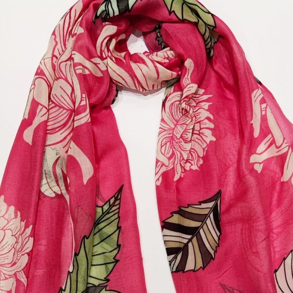 a candy pink scarf with a cream print of oversized chrysanthamums and leaves in shades of green