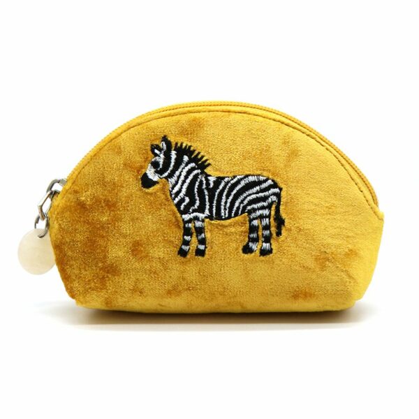a yellow vlvet d shaped pouch with an embroidered black and white zebra on the front.