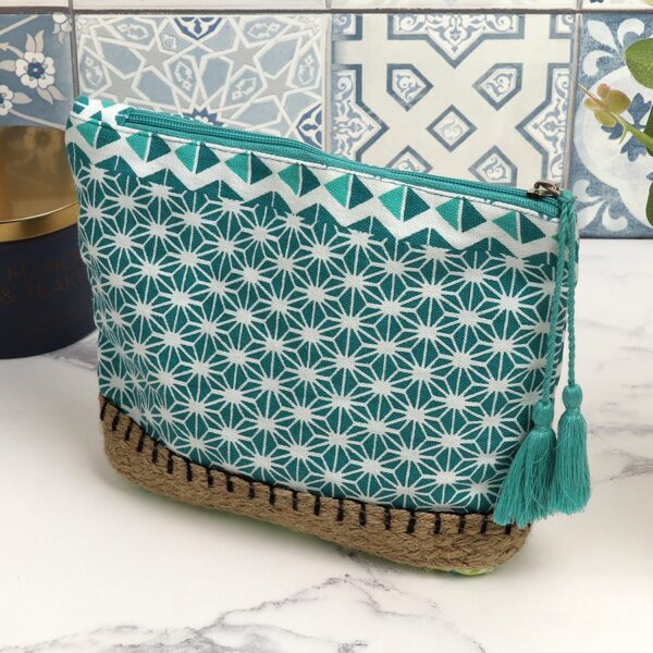a cotton washbag in a starflower geometric tile print in aqua, white and lime, finished with a long aqua tassle