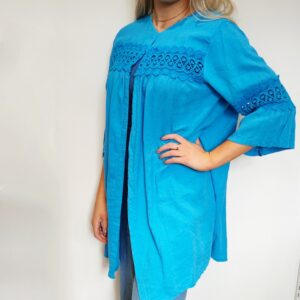 a bright turquoise linen jacket with self coloured lace insets on the bell shaped sleeve and front yoke